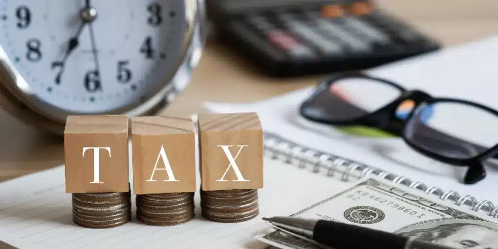 How Much Is $100K After Tax in Ontario? (2026 Guide) 2 $100K after tax in Ontario tax calculation with income tax forms and financial documents