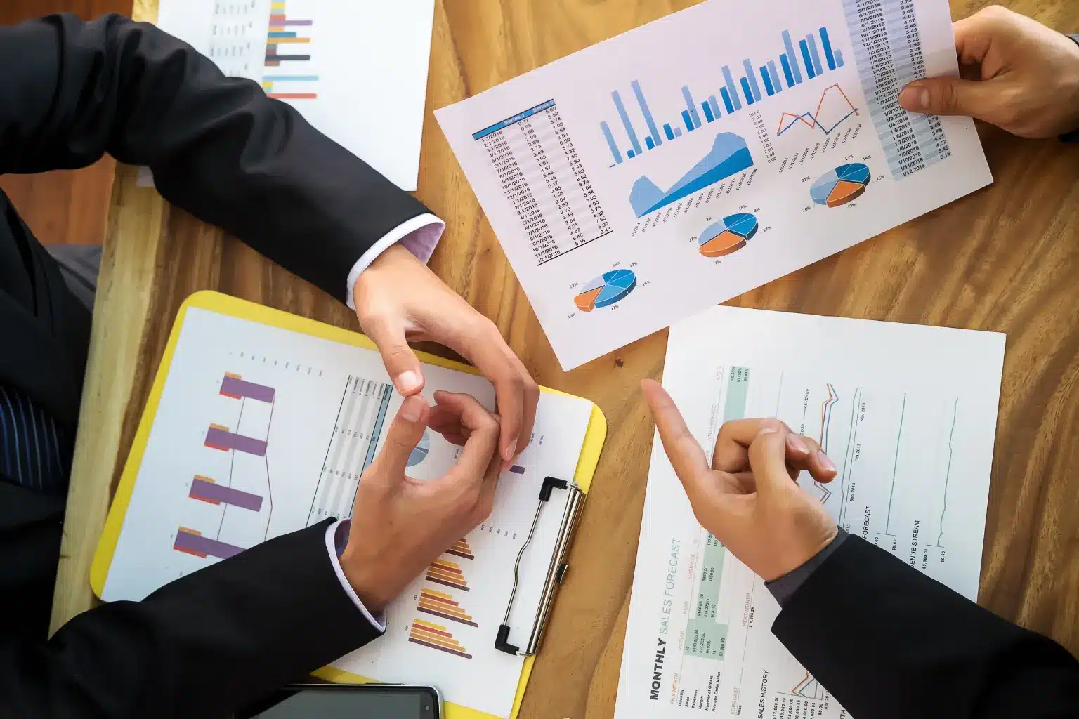 Business owner and advisor reviewing incorporation documents, ownership details and company registration steps in an office.