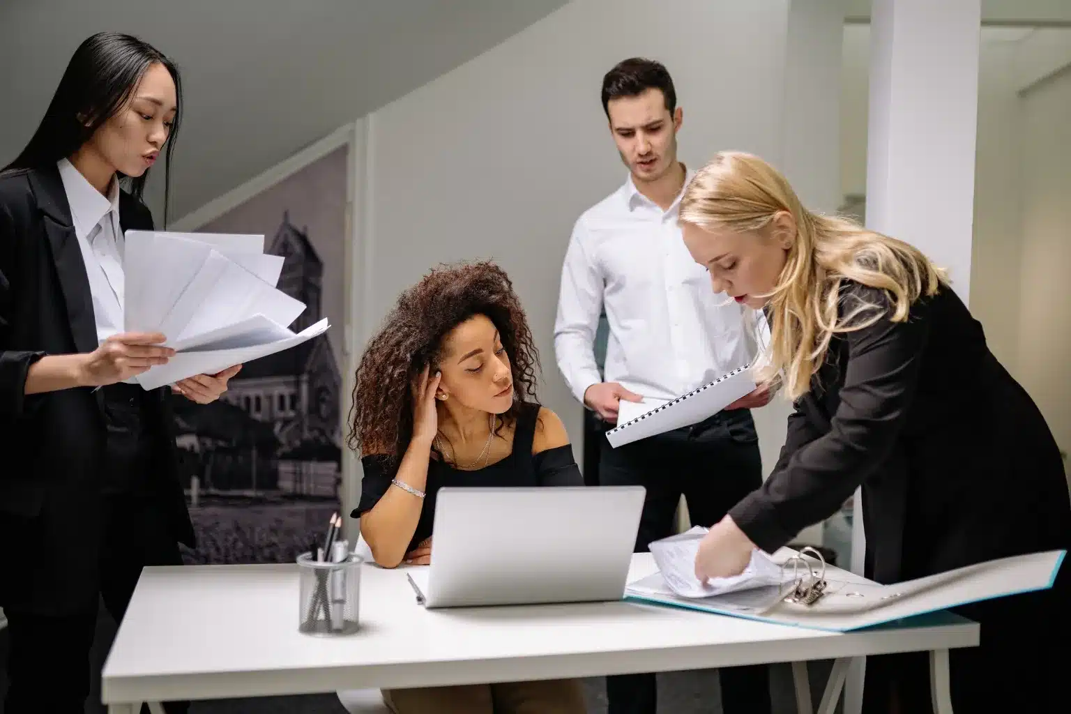 Business professionals reviewing incorporation documents and company formation records in a Toronto office.
