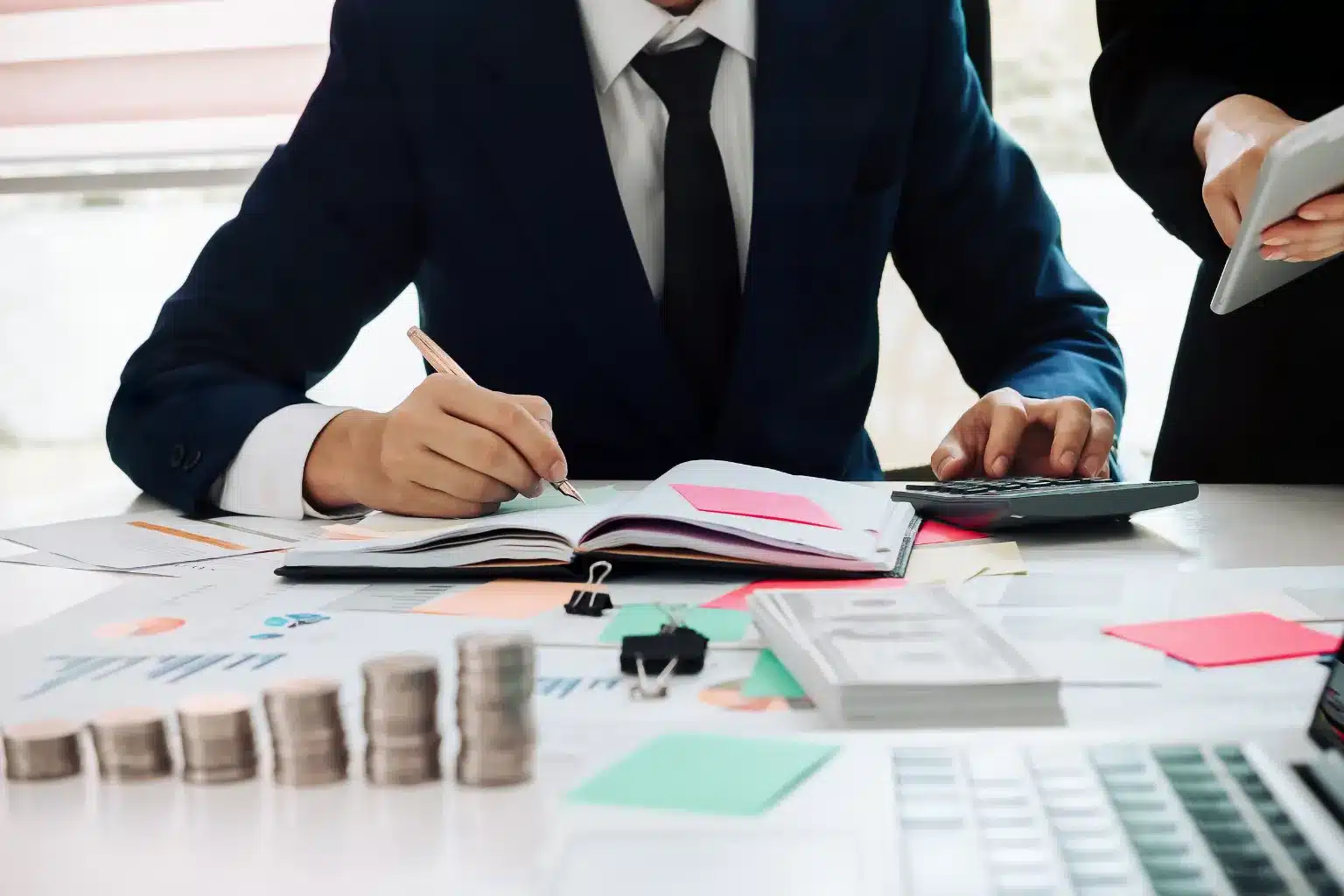 Small business owner and accountant reviewing financial records and tax documents in a Toronto office.