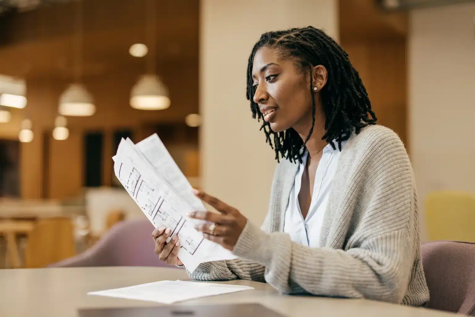 Small business owner and accountant reviewing bookkeeping records, financial reports and tax documents in an office.