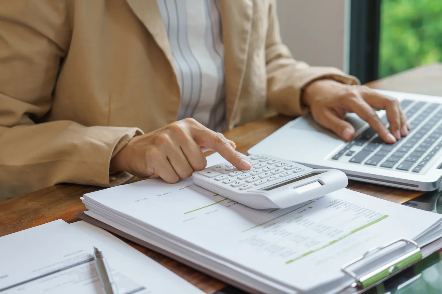 Small business owner and accountant reviewing financial records and tax reporting documents in Toronto.